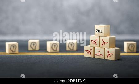 cubes avec des symboles arc et flèche pointant tous vers le Message allemand pour BUT sur la surface de l'asphalte devant arrière-plan concret - illustration 3d Banque D'Images