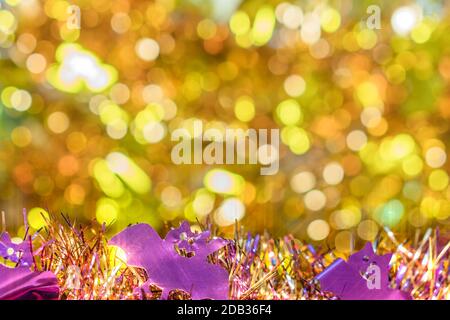 Plein de texture de fond flou d'or décoré de guirlandes de violet smiling faces chauves-souris en premier plan pour célébrer l'halloween. Banque D'Images