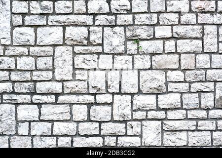 Fond d'un mur en pierres naturelles en forme de bloc Banque D'Images