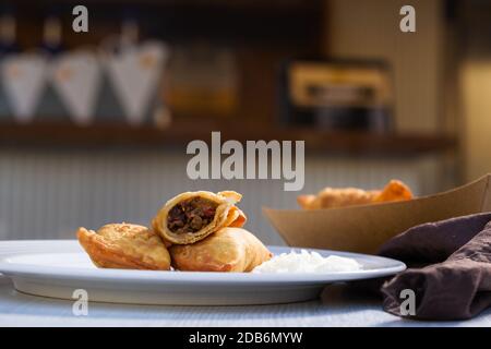 Pâtisseries salées traditionnelles aux empanadas argentins cuites avec farce de bœuf à la viande sur une plaque blanche. Banque D'Images