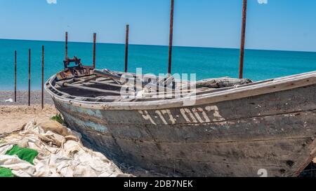 Un vieux bateau en bois sur la mer se trouve sur la plage, perdu Banque D'Images