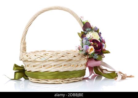 Panier en osier naturel avec fleurs et rubans. Beau noeud sur le côté. Isolé sur un fond blanc Banque D'Images