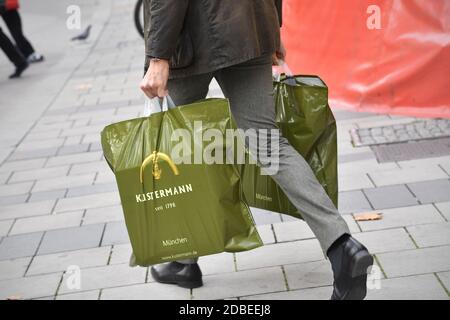 Munich, Allemagne. 17 novembre 2020. Homme en affaires vêtements porte deux sacs en plastique avec le shopping, | usage dans le monde crédit: dpa/Alay Live News Banque D'Images