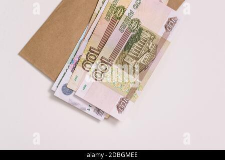 Rouble russe. Des billets de papier de cent roubles et une enveloppe isolée sur un fond blanc. Unité monétaire de la Fédération de Russie. Banque D'Images