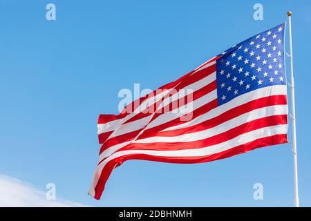 Drapeau américain agitant dans le vent, mouvement du drapeau américain sur le ciel bleu, drapeau national des États-Unis d'Amérique. Les étoiles et les rayures des États-Unis Banque D'Images