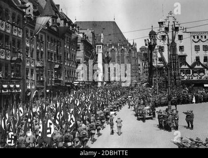 Vue sur les formations de la sa pendant leur défilé le long de la soi-disant Adolf-Hitler-Platz au Congrès du Parti nazi à Nuremberg. Dans la Mercedes à droite Adolf Hitler prend le salut. En arrière-plan se trouve une partie de l'église Saint-Sebaldus. Banque D'Images