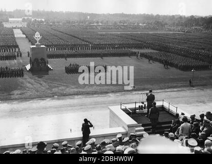 Adolf Hitler donne un discours aux 54,000 hommes du Reich Labor Service sur le champ de Zeppelin. Derrière lui se trouve Konstantin Hierl, à gauche Heinrich Hoffmann prend une photo. Au milieu de la place se trouve le Mémorial du travail, où a eu lieu la commémoration des morts. Banque D'Images