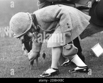 « le jour de l'armistice, une petite fille croise une croix en bois sur la pelouse du « champ du souvenir » à l'abbaye de Westminster à Londres. » Banque D'Images