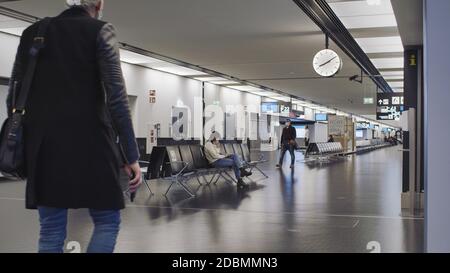 Vienne, Vienne/Autriche - 2 novembre 2020 : passagers en attente à l'aéroport de Vienne. Seulement quelques personnes voyageant et beaucoup de portes fermées. Banque D'Images