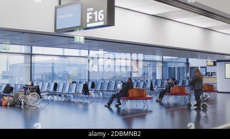 Vienne, Vienne/Autriche - 2 novembre 2020 : passagers en attente à l'aéroport de Vienne. Seulement quelques personnes voyageant et beaucoup de portes fermées. Banque D'Images