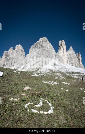 Petit coeur de pierres assemblées devant les sommets de montagne de Tre Cie de Lavaredo (italien, les trois sommets de Lavaredo) dans les Dolomites Sexten, Italie. Banque D'Images
