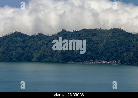 Vue aérienne sur le lac Batur jusqu'au village traditionnel de Trunyan. Dans ce village, les habitants enterrent leur défunt au-dessus de la terre. Terunyan est l'un des th Banque D'Images