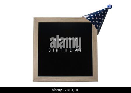 Un panneau à motif bouleau et encadré qui indique un joyeux anniversaire en lettres blanches avec un chapeau bleu foncé sur un fond blanc pur Banque D'Images