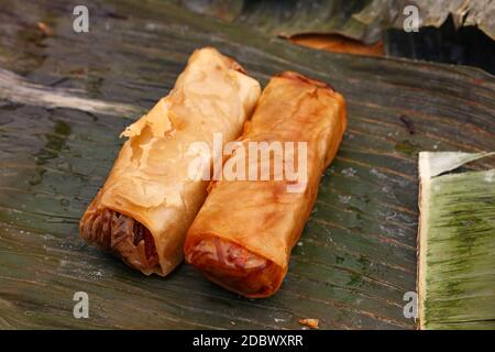 Partie de deux rouleaux de printemps croustillants frits, une cuisine asiatique traditionnelle, snack apéritif servi sur le vert des feuilles de bananier, high angle view Banque D'Images