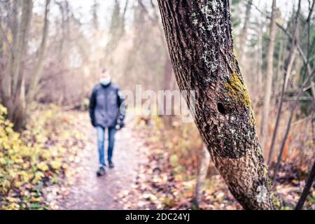 Corona dépression, anxiété, solitude et social distance concept. Seul homme triste marchant dans la forêt pendant l'isolement du coronavirus. Banque D'Images