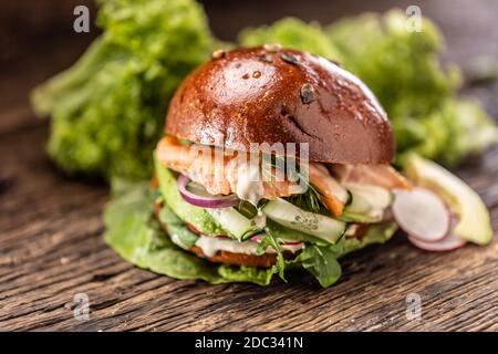Hamburger de saumon farci avec salade de légumes, avocat et aneth Banque D'Images