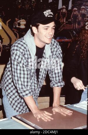 Beverly Hills 90210 l'acteur Luke Perry de Beverly Hills 90210 à Planet Hollywood à New York, le 4 février 1993, met ses empreintes à la main dans une dalle de ciment. Banque D'Images