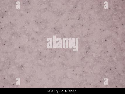 Gros plan de marbre rose pâle avec petites taches noires. Arrière-plan, texture. Banque D'Images