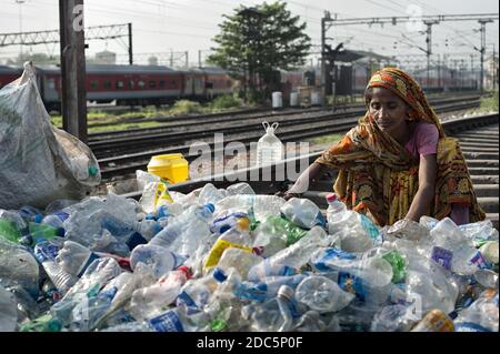 Une femme appartenant à la caste des intouchables (Dalit) choisit des bouteilles et d'autres récipients en plastique collectés dans les rues de Kolkata pour vendre. Banque D'Images