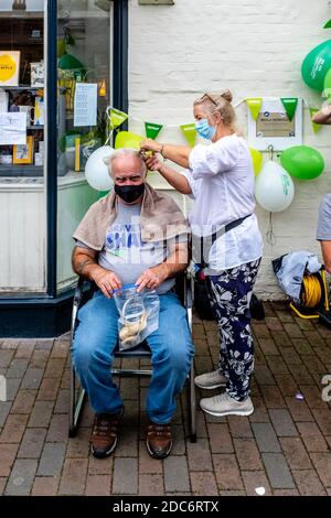 Des hommes qui ont rasé leurs cheveux pour recueillir de l'argent pour la Macmillan cancer Care Charity, High Street, Lewes, East Sussex, Royaume-Uni. Banque D'Images