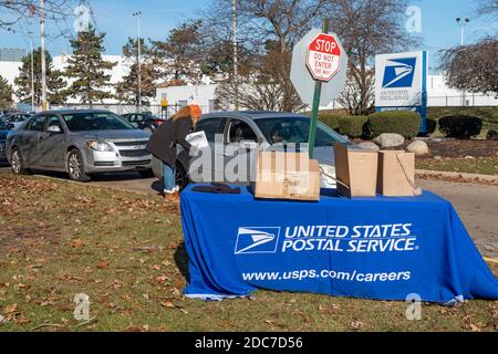 Allen Park, Michigan, États-Unis. 18 novembre 2020. Pendant la pandémie du coronavirus, le Service postal des États-Unis a organisé des salons de l'emploi au drive dans les collectivités de Detroit et de banlieue. USPS embauche pour des postes permanents et saisonniers. Jewel Mays a remis des renseignements sur l'embauche aux candidats à l'extérieur du centre de distribution du réseau Allen Park. Crédit : Jim West/Alay Live News Banque D'Images