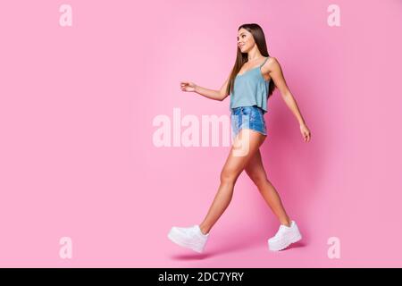 Vue sur toute la longueur de la taille de son corps elle belle-look attrayant jolie jolie magnifique et enjouée contenu brun-cheveux fille marchant isolée plus de Banque D'Images