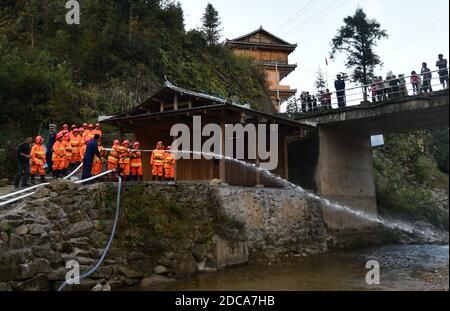 (201120) -- RONGSHUI, 20 novembre 2020 (Xinhua) -- Le 19 novembre 2020, des volontaires féminins participent à un exercice d'incendie sous la direction de pompiers professionnels au village de Wuying, un village isolé habité par le groupe ethnique Miao à la frontière entre la région autonome de Guangxi Zhuang dans le sud de la Chine et la province de Guizhou dans le sud-ouest de la Chine. Alors que les maisons de style architectural local du village sont soutenues par une structure boisée, une équipe de femmes pompiers volontaires est formée pour protéger leur village, car la plupart des jeunes et des hommes d'âge moyen s'aventurent en tant que migrants. (Xinhua/Huang Xiaobang) Banque D'Images