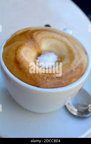 le sucre s'infiltre dans un café à l'intérieur d'un cappuccino La ville sicilienne d'Acireale Banque D'Images