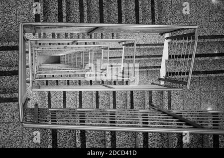 Main courante moderne en acier inoxydable avec escaliers gris, vue du dessus Banque D'Images