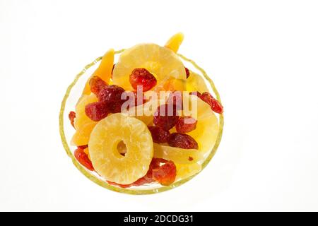 Rondelles de melon jaune confites, anneaux d'ananas et cornouiller dans un vase en verre sur fond blanc, vue de dessus dans un vase en verre sur fond blanc, vue de dessus vi Banque D'Images