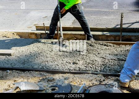 Poser un nouveau trottoir dans du béton humide sur du béton fraîchement coulé trottoirs en béton Banque D'Images