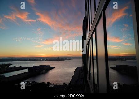 San Diego, Californie, États-Unis. 19 novembre 2020. Le soleil se couche sur la baie de San Diego et se reflète dans les fenêtres d'un hôtel SpringHill Suites by Marriott. Le tourisme, une des principales industries de San DiegoÃs, a été touché par le ralentissement des voyages dû à Covid-19. Crédit : K.C. Actualités en direct Alfred/ZUMA Wire/Alay Banque D'Images