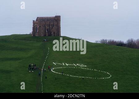 Abbotsbury, Dorset, Royaume-Uni. 22 novembre 2020. Météo au Royaume-Uni : l’événement caritatif annuel bougies sur la colline à la chapelle St Catheine’s Chapel à Abbotsbury, dans le Dorset, se poursuit au crépuscule avec le NHS écrit dans des lumières au-dessus du cercle de lumière sur le chemin menant à la chapelle pendant le confinement de Covid-19, lors d’une soirée de drizzly. Crédit photo : Graham Hunt/Alamy Live News Banque D'Images