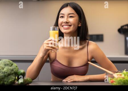 Femme coréenne mince boire du jus perdre du poids à la maison Banque D'Images