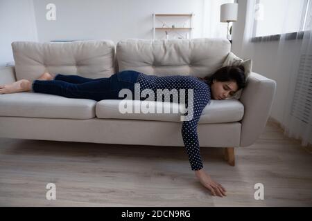 Femme asiatique fatiguée et épuisée dormant sur le canapé à la maison Banque D'Images