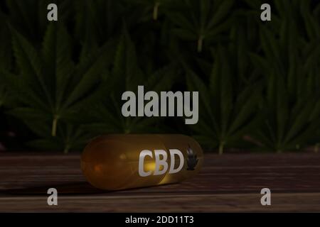 Capsule de CBD sur l'ancienne table avec des plantes de chanvre et des feuilles en arrière-plan. Banque D'Images