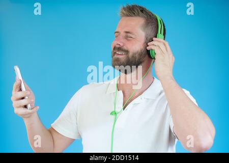 Portrait d'un jeune homme heureux écoutant de la musique casque et danse Banque D'Images