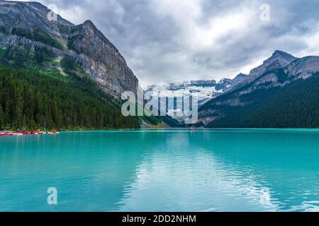 Canoë sur le lac Louise en été. Les touristes apprécient les loisirs aquatiques sur le lac turquoise dans le parc national Banff, Alberta, Canada. Banque D'Images