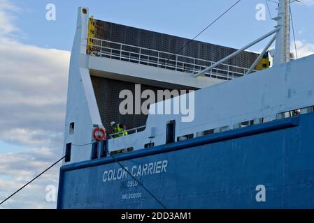 Deux matelots de pont sur un grand cargo sécurisent les lignes d'amarrage pendant l'amarrage. Banque D'Images