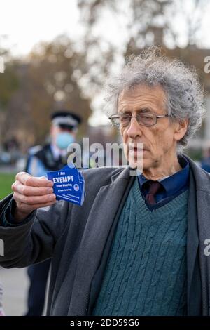 Londres, Royaume-Uni. 24 novembre 2020. Piers Corbyn (frère de l'ancien leader travailliste Jeremy Corbyn) a mené une petite manifestation anti-vax anti-masque et a remis des cartes d'exemption de masque aux passants et aux médias. Il était accompagné d'un homme portant une seringue géante, qui a été interrogé par la police sur le pont de Westminster. Crédit : Ian Davidson/Alay Live News Banque D'Images