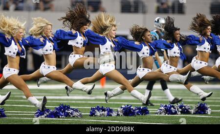 The Dallas Cowboys Cheerleaders perform by the All-Star stage as FOX  broadcast personalities Jamie Little, left rear, and Adam Alexander, right  rear, report during the NASCAR Cup Series All-Star auto race at