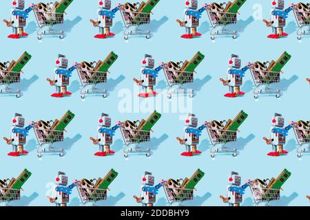 Motif de jouets robots vintage poussant les chariots de magasinage miniatures remplis avec équipement électronique Banque D'Images
