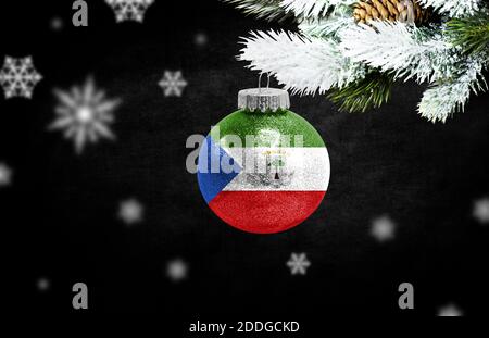 Bonne année 2021, drapeau de la Guinée équatoriale sur un jouet de noël, décorations isolées sur fond sombre. Concept de noël créatif. Banque D'Images