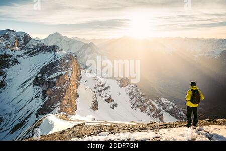 Dernières étapes avant le montage en sommet des serles. Grimpeur dans une veste jaune monte une montagne contre un ciel bleu. Vêtements d'alpinisme, Banque D'Images