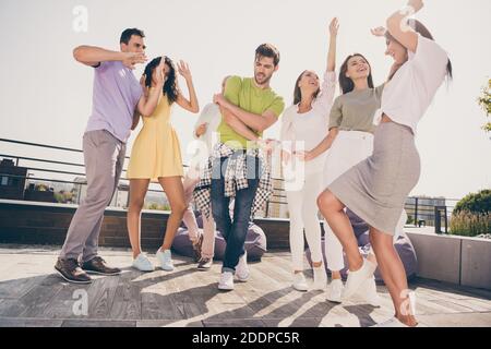 Photo d'optimistes jolies filles les gars de handsome ont le plaisir de danser faites la fête sur la terrasse du toit Banque D'Images