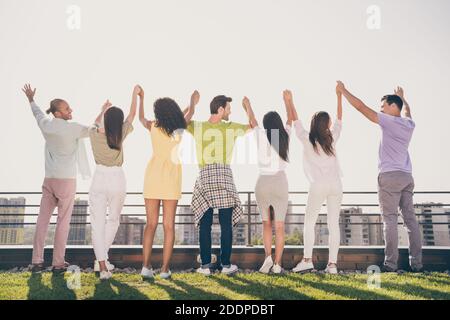 Photo de cool jolies filles les gars de main debout tenir les mains faites une fête sur la terrasse du toit à l'extérieur Banque D'Images