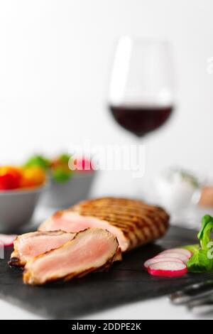 Pavé de boeuf grillé à point sur le conseil de pierre avec des légumes frais et un verre de vin rouge. Des photos avec une faible profondeur de champ. Banque D'Images