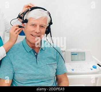 Audiométrie d'impédance, diagnostic de déficience auditive. Un homme âgé qui obtient un test auditif dans une clinique auditive, gros plan. Banque D'Images