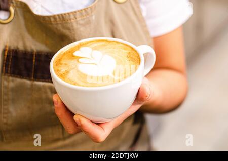 Une femme péruvienne Barista crée un art latte dans un café, un concept de restauration Banque D'Images