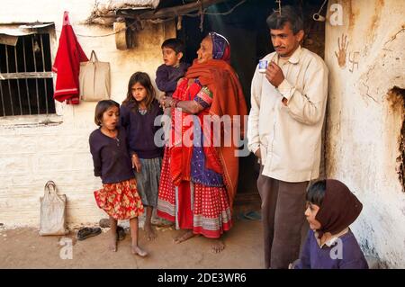 Family in their home entrance - Village in Rajasthan, India Stock Photo